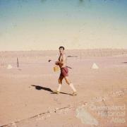 Pilot practising golf on the Birdsville airstrip, 1972