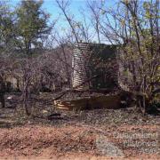 Stumps and corrugated iron tanks, Mungana